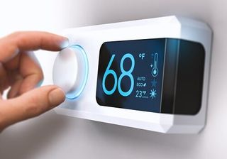 Man Adjusting Temperature — HVAC in Spartanburg, SC