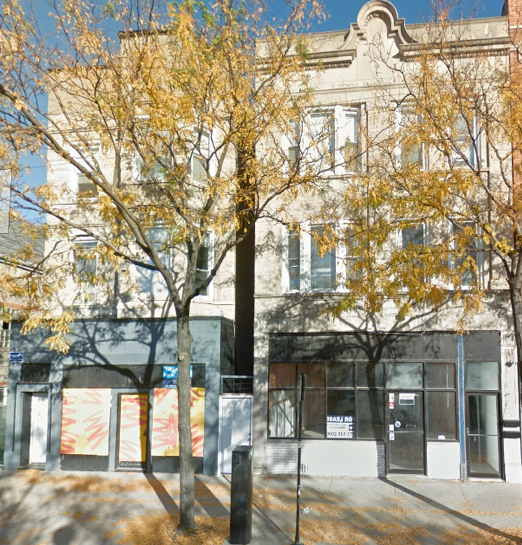 A building with a few trees in front of it