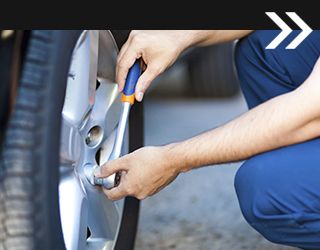 Technician Fastening Wheel to Vehicle in Winston-Salem, NC