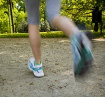 Woman running outdoors in park - motion blur