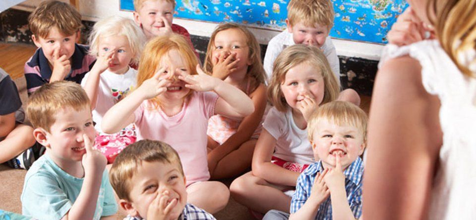 Kids listening to their teacher