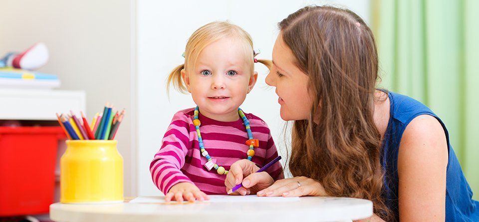 A baby girl with her teacher