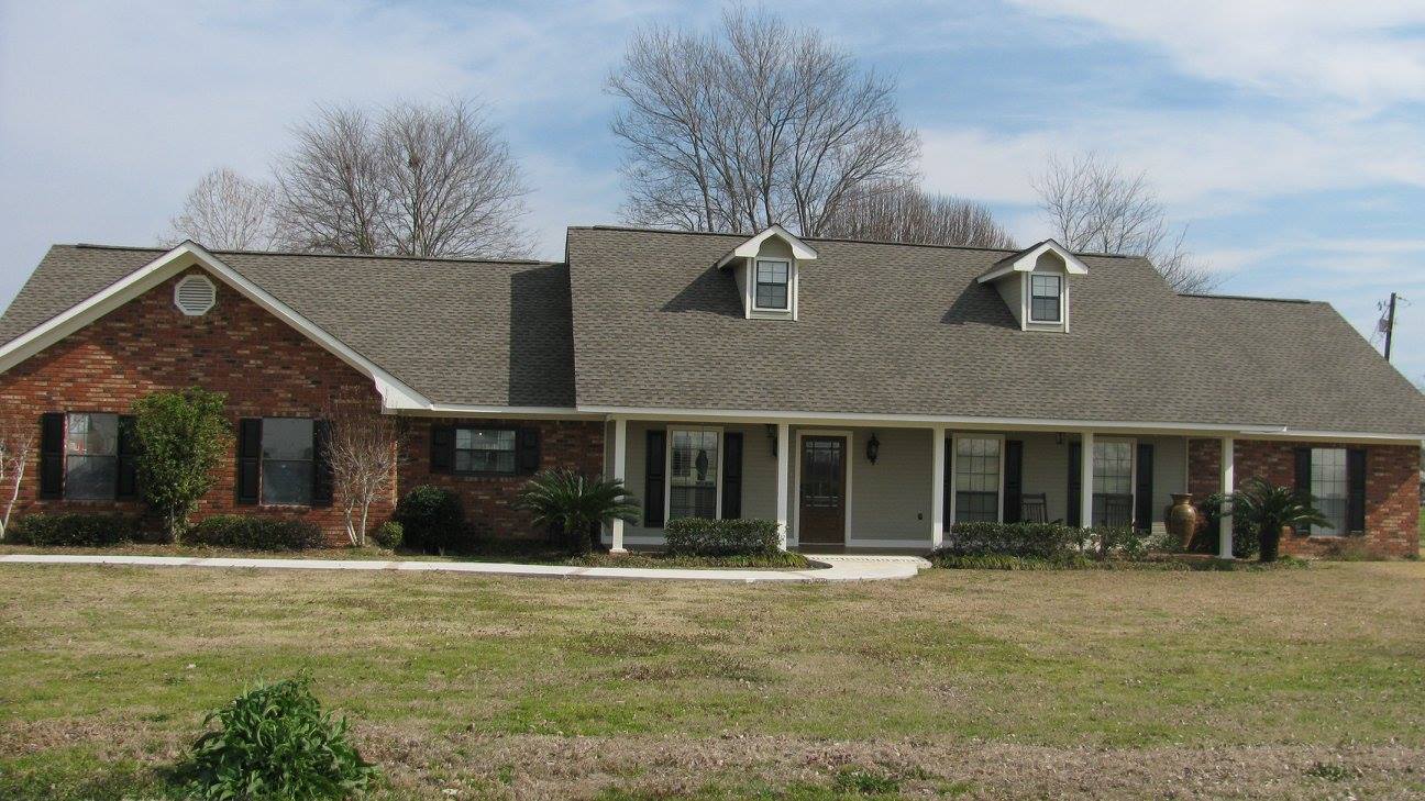 large brick cape cod style home