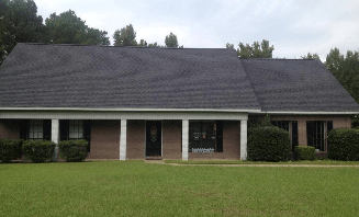 shingled roof on brick house with columns