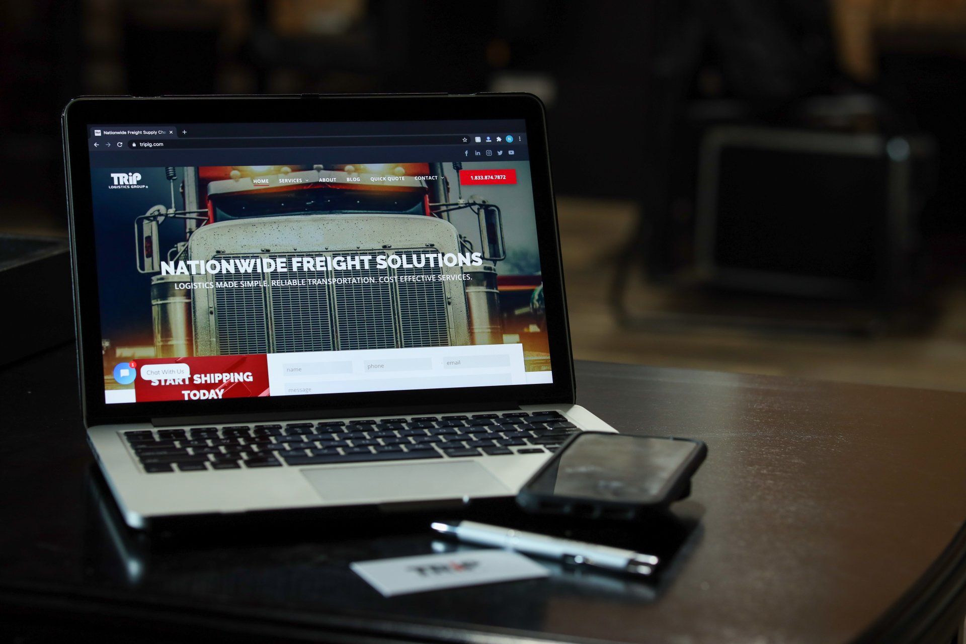 A laptop computer is open to a website on a table.