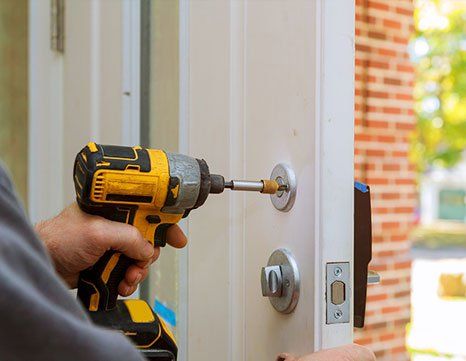 Man Installing New Lock — Durham, NH — H & H Locksmith
