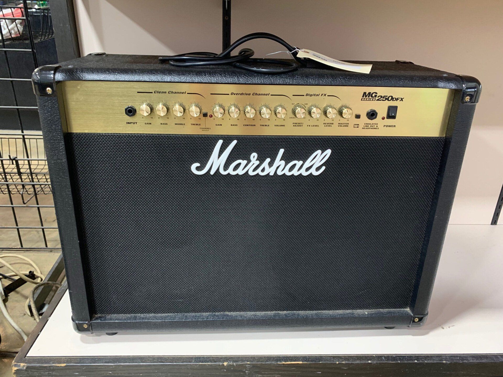 A marshall guitar amplifier is sitting on a white table.