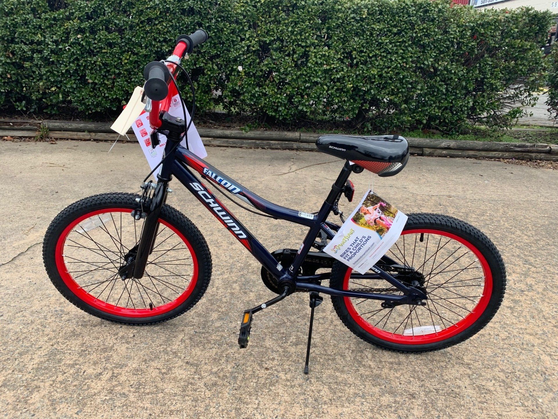 A black and red bicycle is parked on the side of the road.