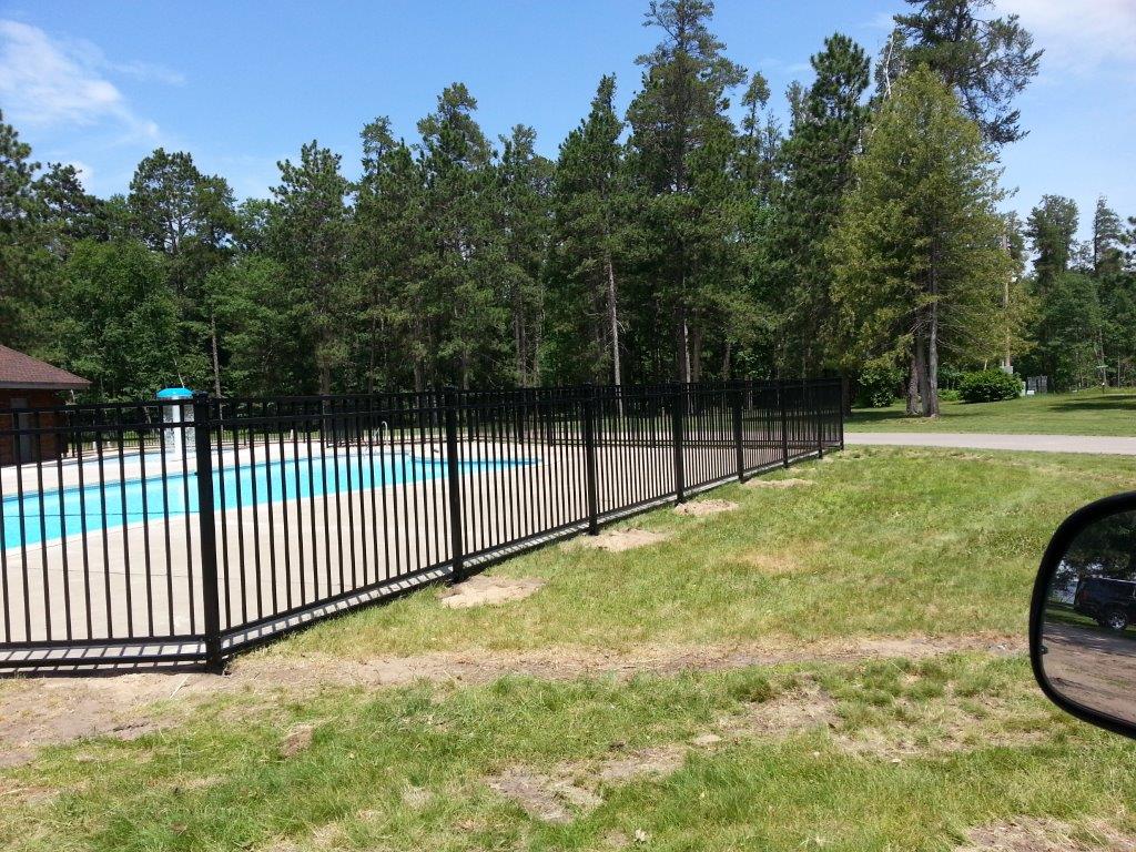 Specialty Fence Repair — Black Fence with Pool Background in Deerwood, MN