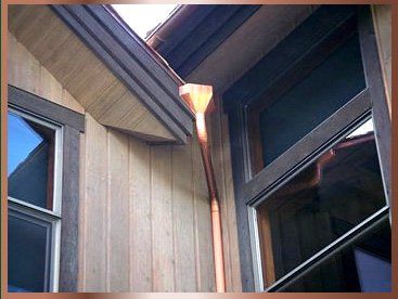 Downspout near two window - Gutter Cleaning in Edwards, CO