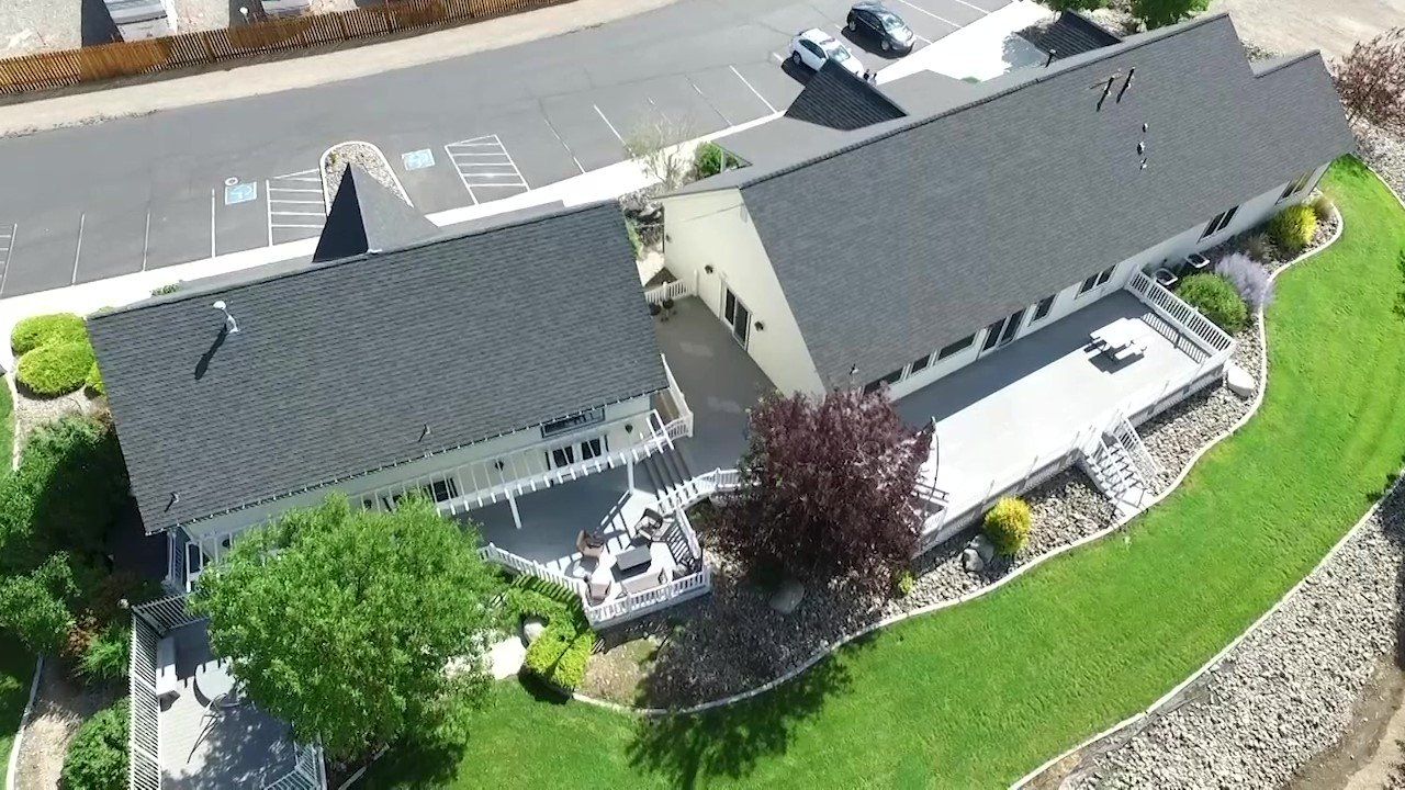 An aerial view of a house with a black roof