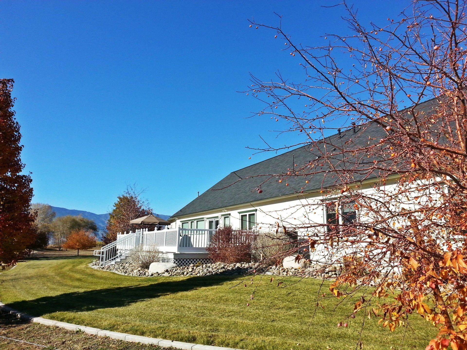 A large white house with a large lawn in front of it