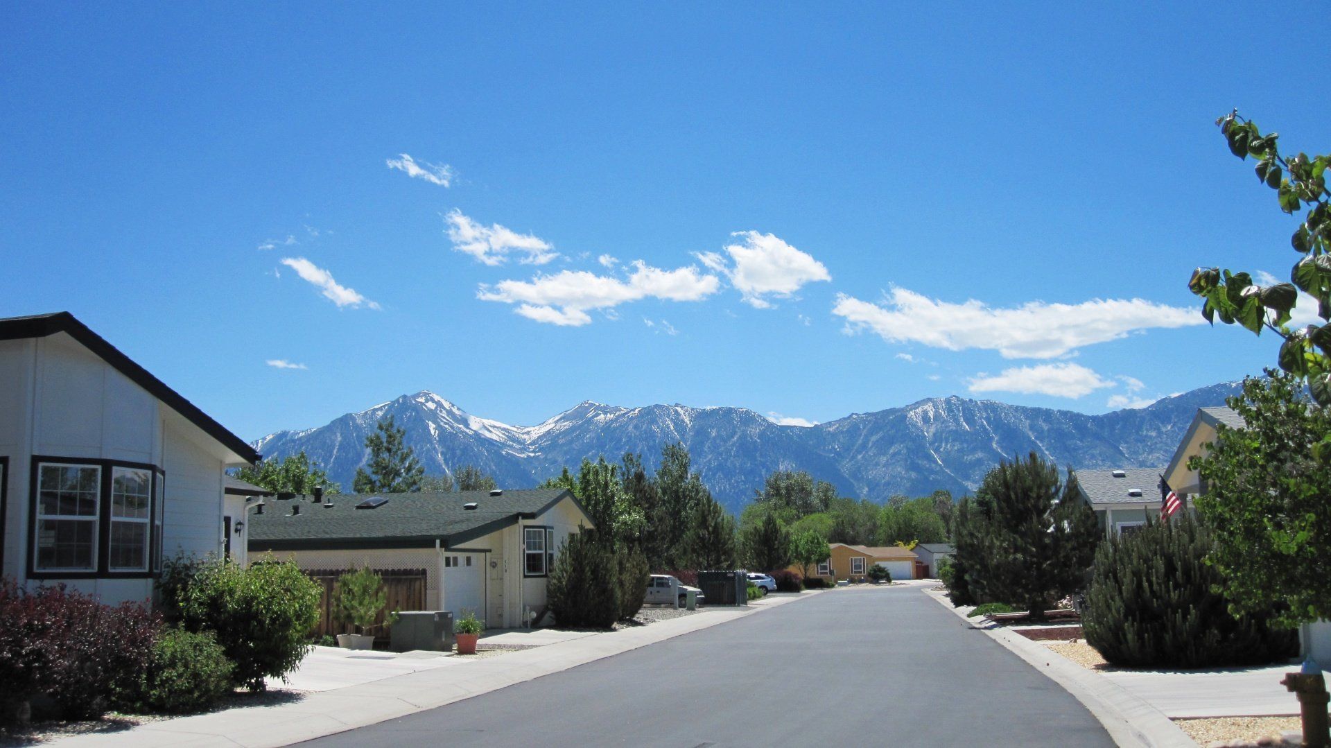 A residential neighborhood with mountains in the background