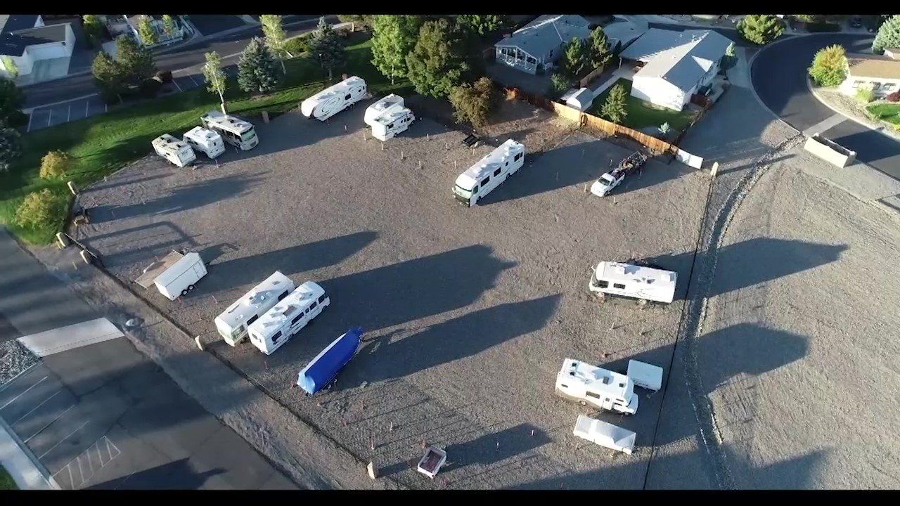An aerial view of a parking lot with a lot of rvs parked in it