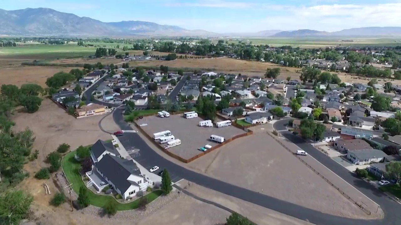 An aerial view of a small town with mountains in the background.