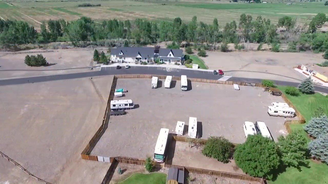 An aerial view of a parking lot with a lot of rvs parked in it.