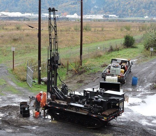 Terrain Drilling Services — Men Working on Rough Terrain Drill in Hubbard, OR