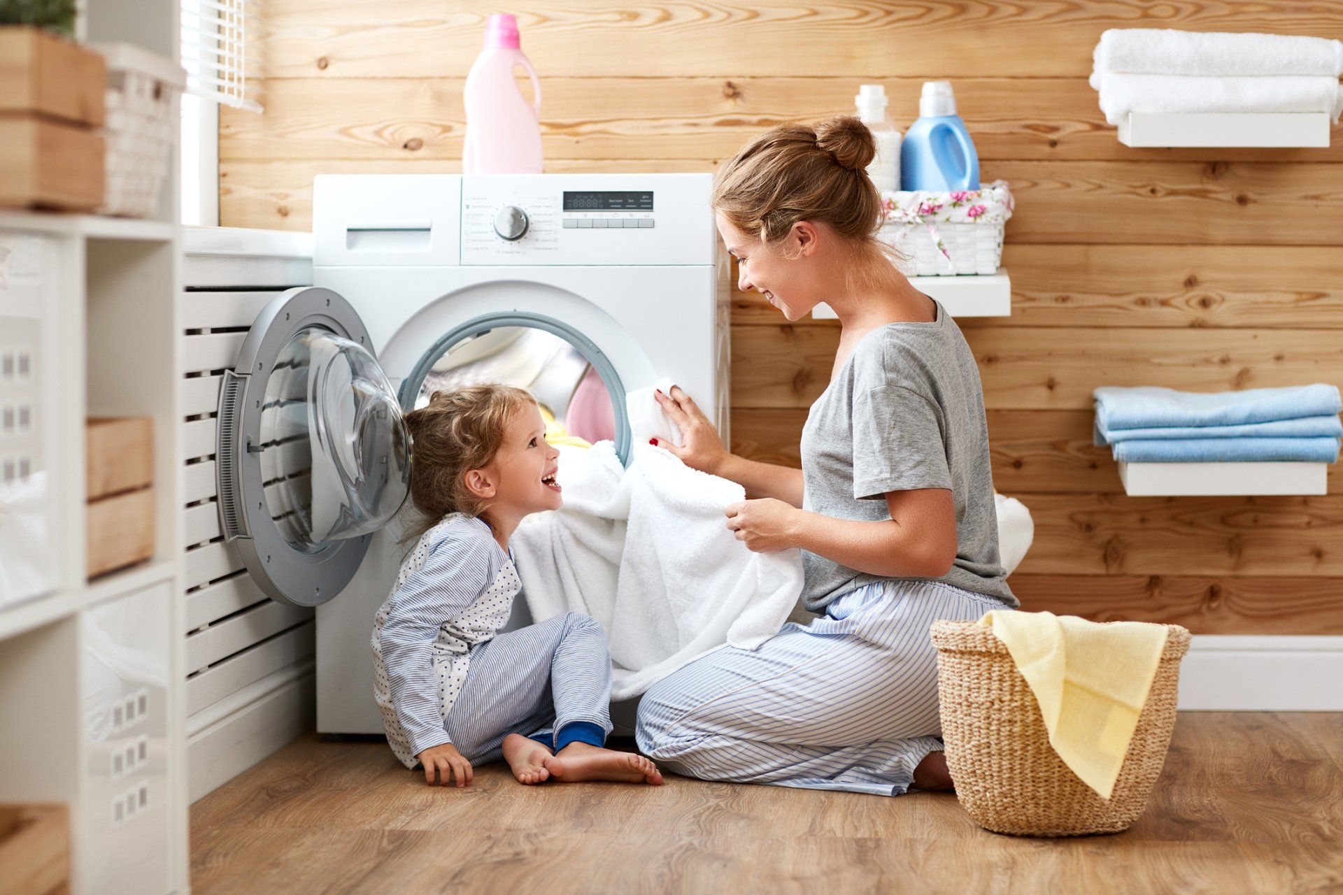 Man Repairs Washing Machine in Laundry — Niceville, FL — Cal's Appliance Repair Man Repairs Washing Machine in Laundry — Niceville, FL — Cal's Appliance Repair