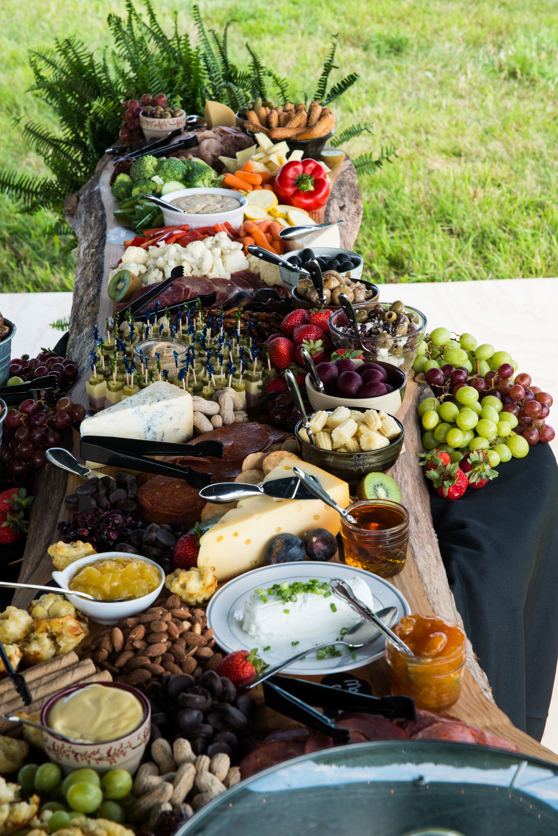 Luncheon table with fresh fruits, aged swiss, cheddar, and bleu cheeses.  Accented with fresh fruit preserves, nuts, and aged meats.