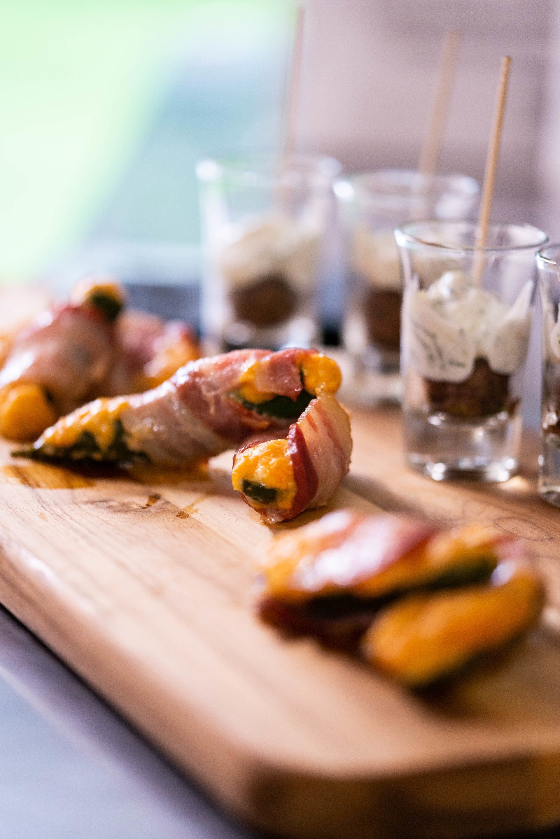 Baked jalapeno peppers wrapped in aged cheddar cheese and bacon.