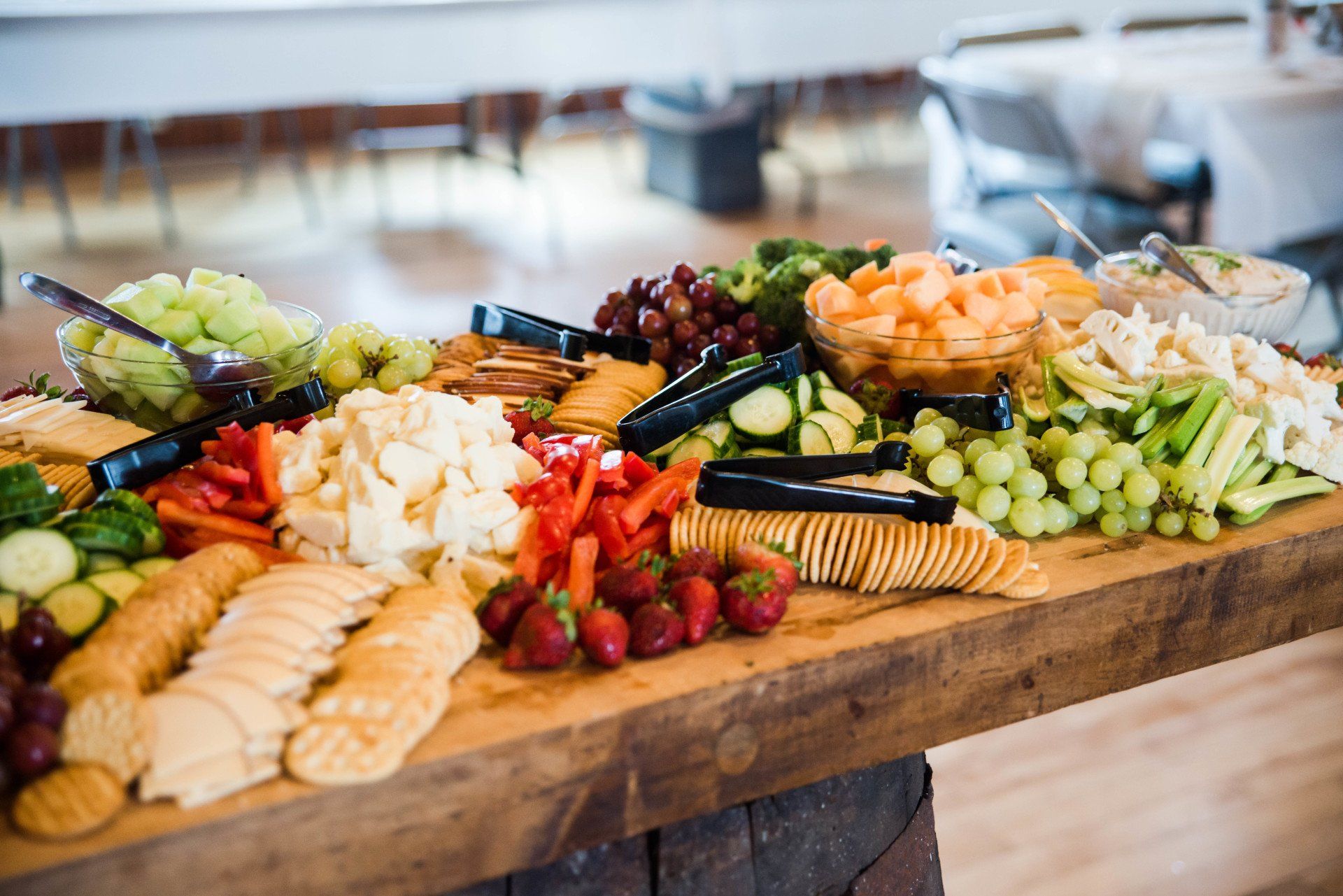 Luncheon cheeseboard with swiss and aged cheddar, gourmet crackers, fresh grapes and apples.