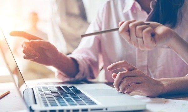 Insurance Broker Helping Client Pick Plan on Computer