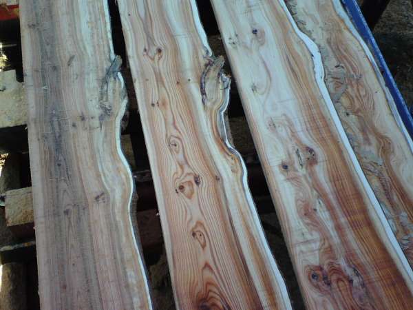 Three pieces of wood are sitting on top of each other on a table.