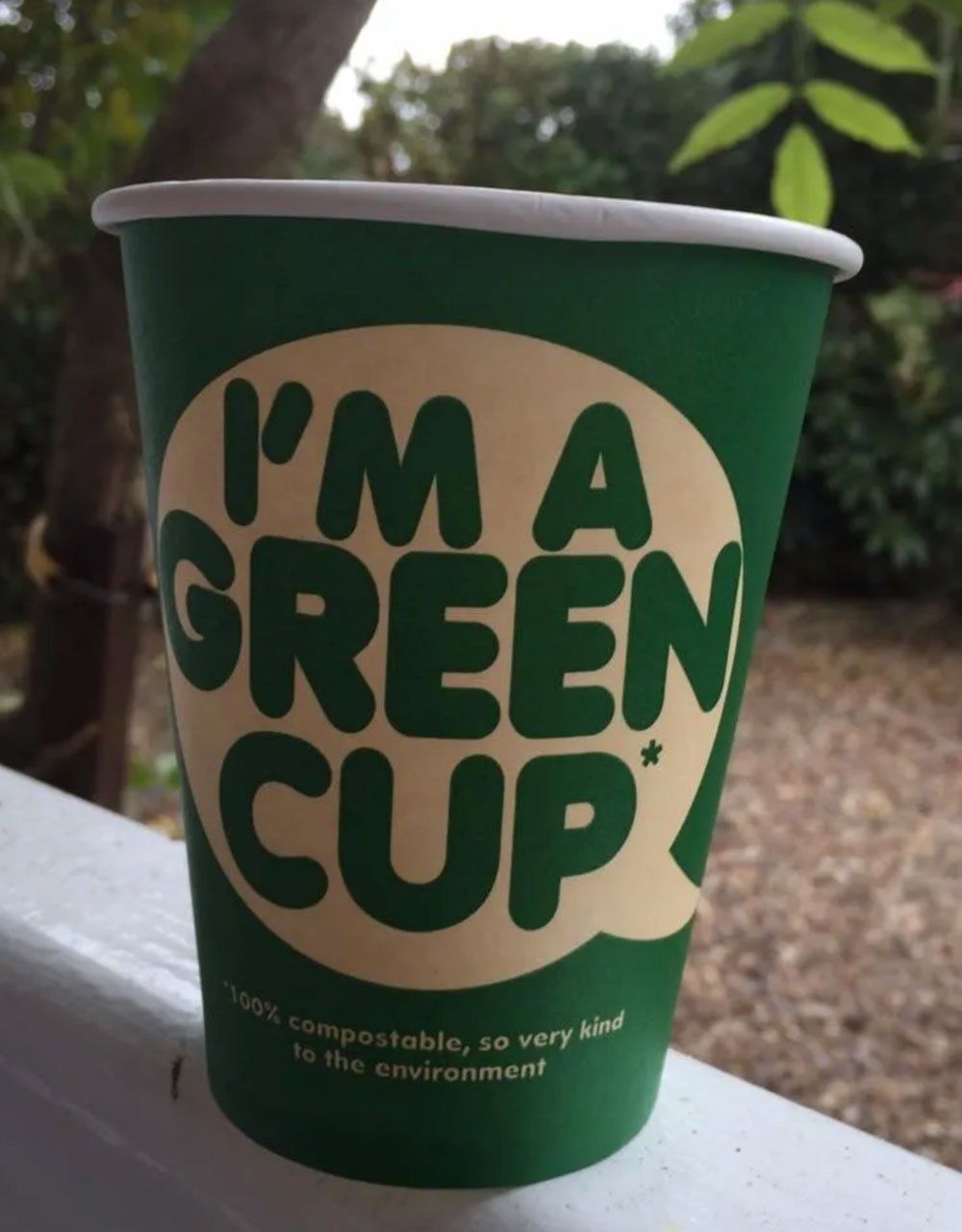 A green cup that says i 'm a green cup