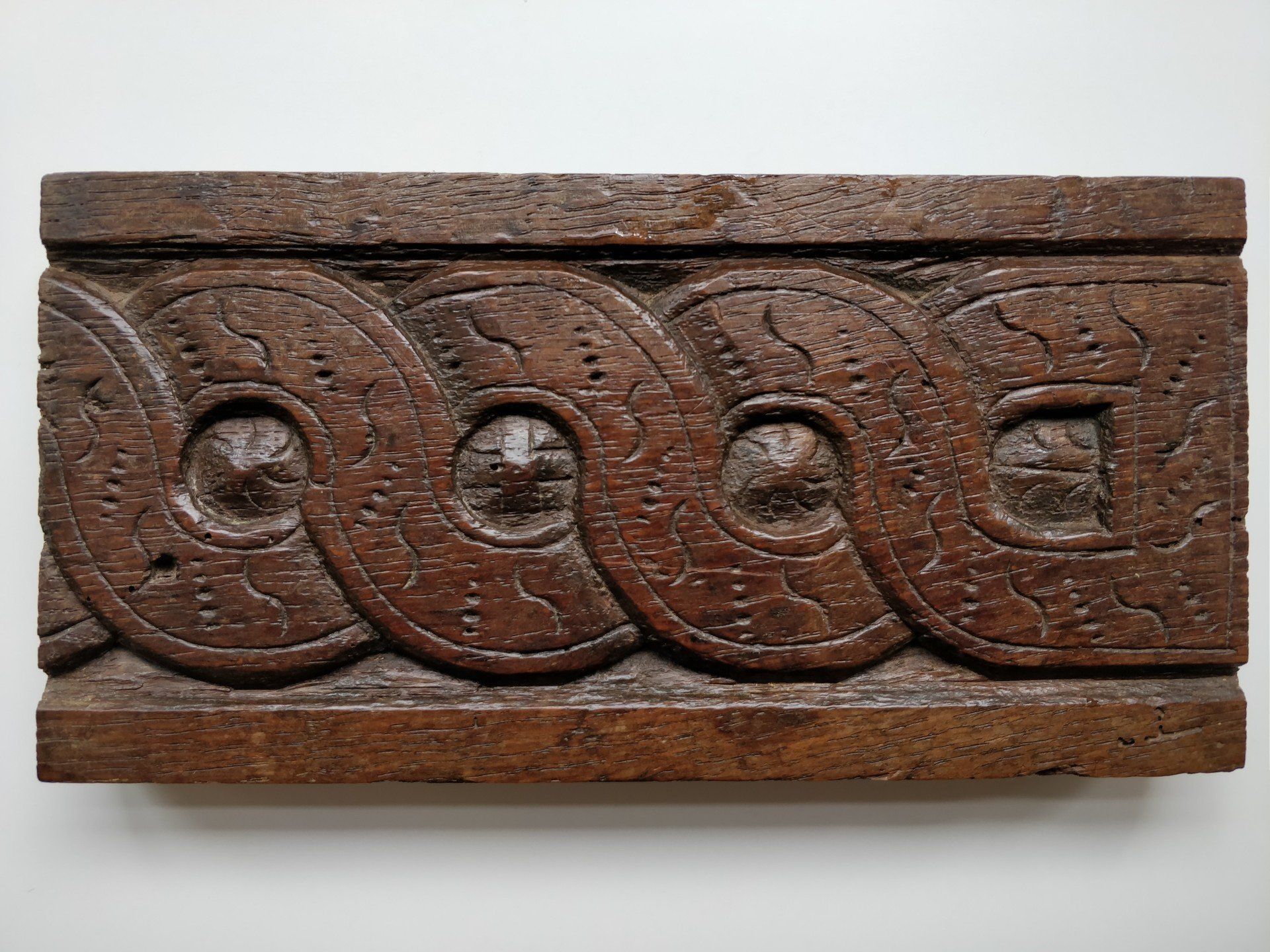 A piece of wood with a circular design on it