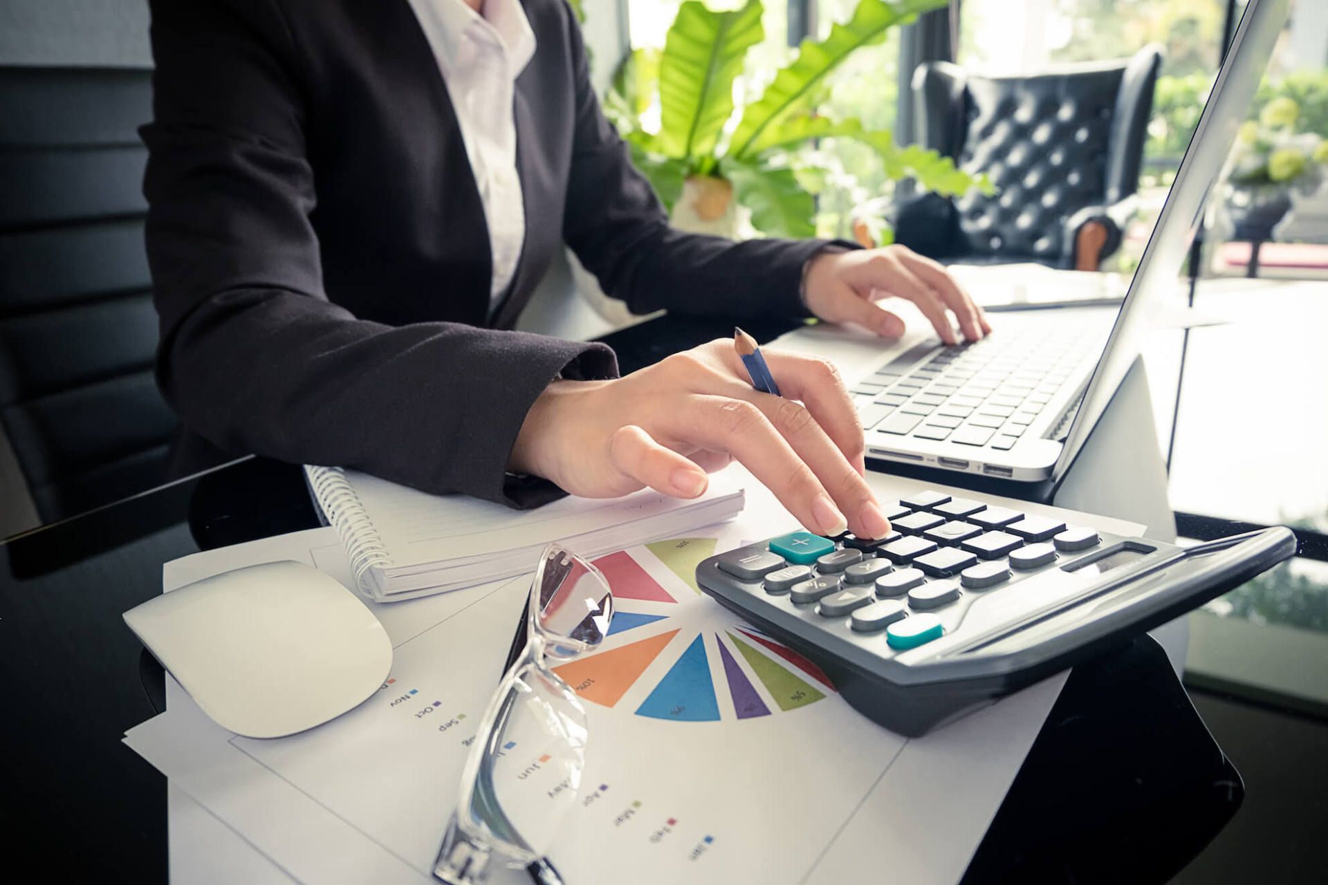 female busy with accounting on laptop and calculator