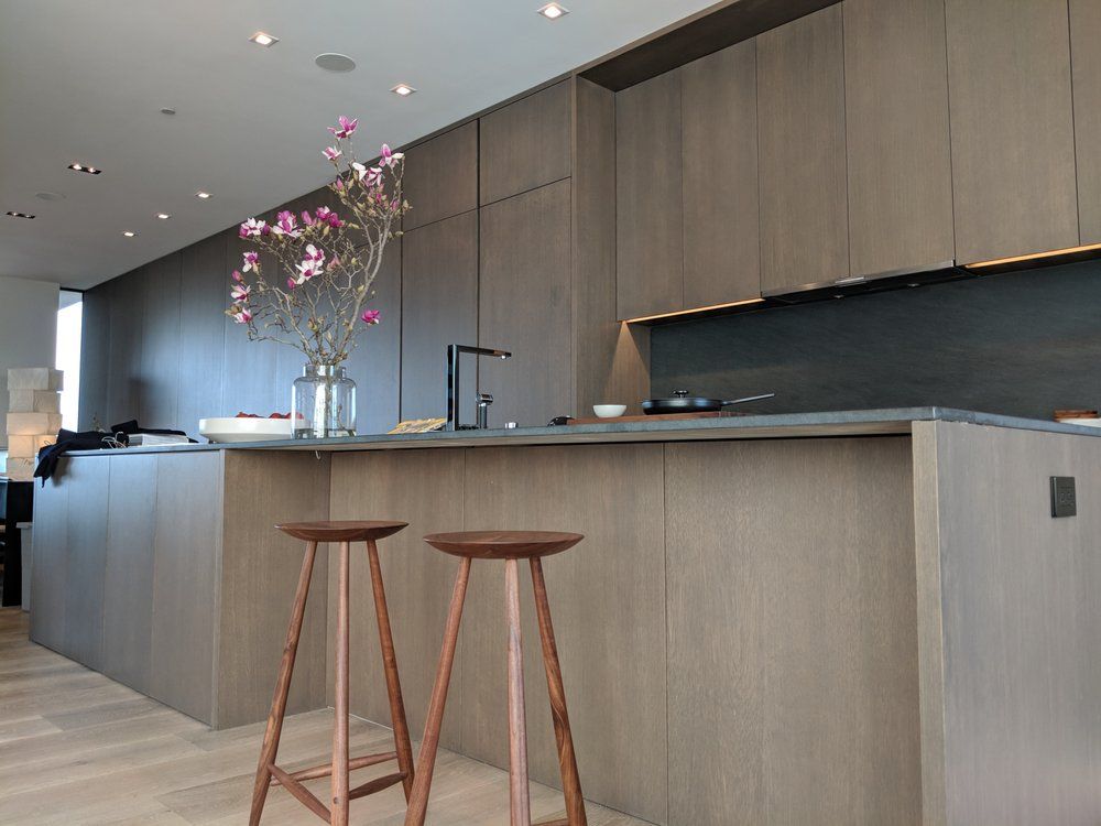 Kitchen island with two bar stools and new kitchen cabinets.