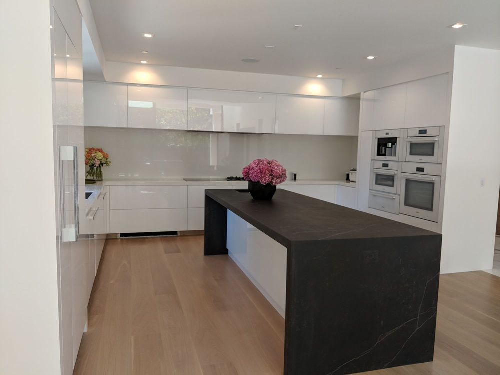 Kitchen remodel with island, kitchen cabinets, and built-in ovens.