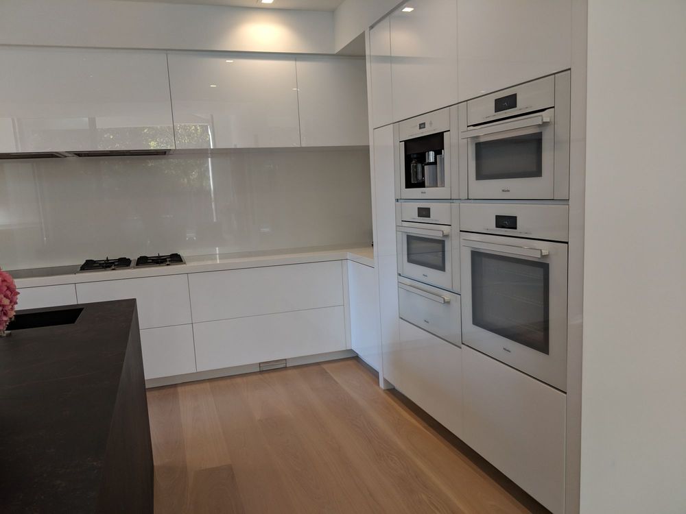 Kitchen remodel featuring new white cabinets and built-in ovens.