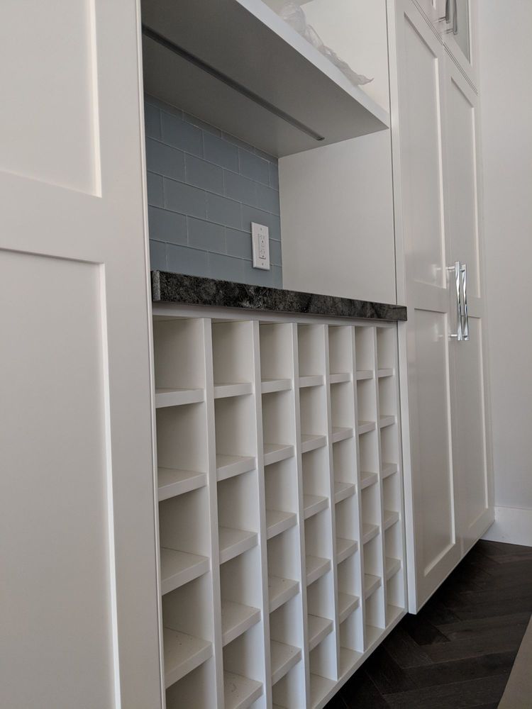 Custom craft cabinets with shoe storage and counter.