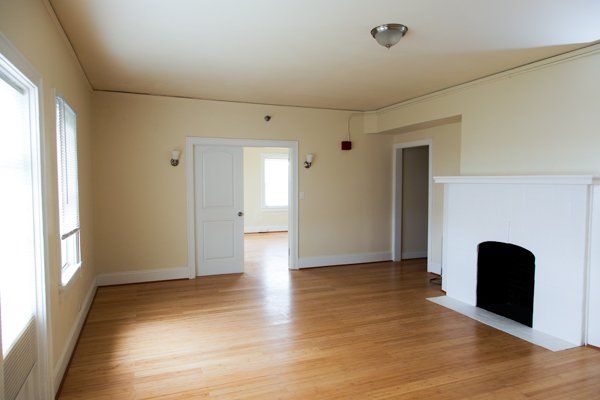 A view of the living area with a white fireplace.