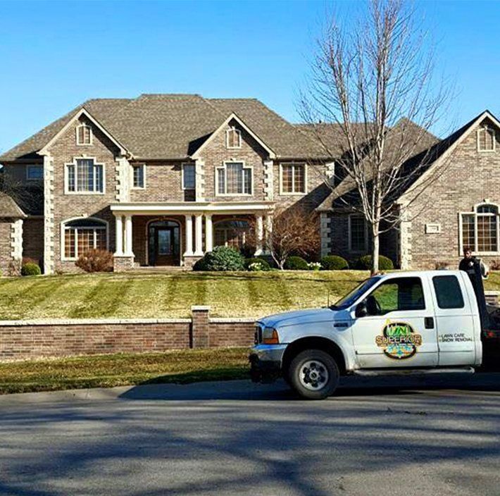 A large brick house with a truck parked in front of it