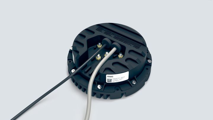 A close up of a black object with wires coming out of it.