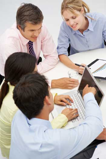 team around a laptop