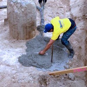 Foundations laying large concrete foundation