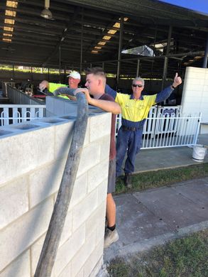 Block Fills concrete worker with hat filling wall with mix