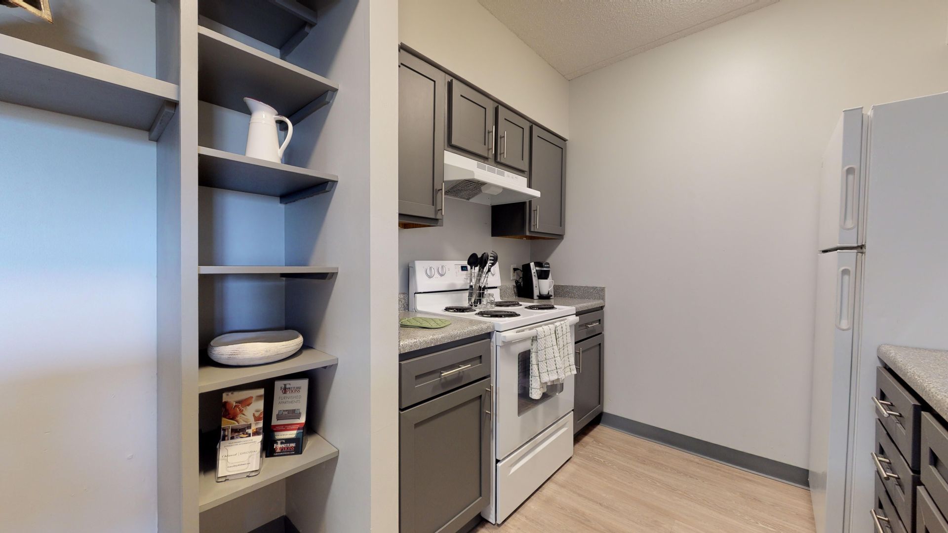 Des Moines, IA Apartments- The Village at Grays Lake- Grey Cabinets with Spacious Counters with Wood-Style Floors