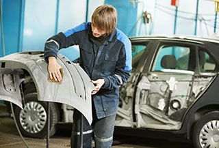 Collision Repair Technician Working on Auto Body