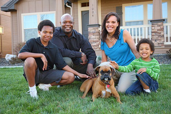 A family of four with their dog.