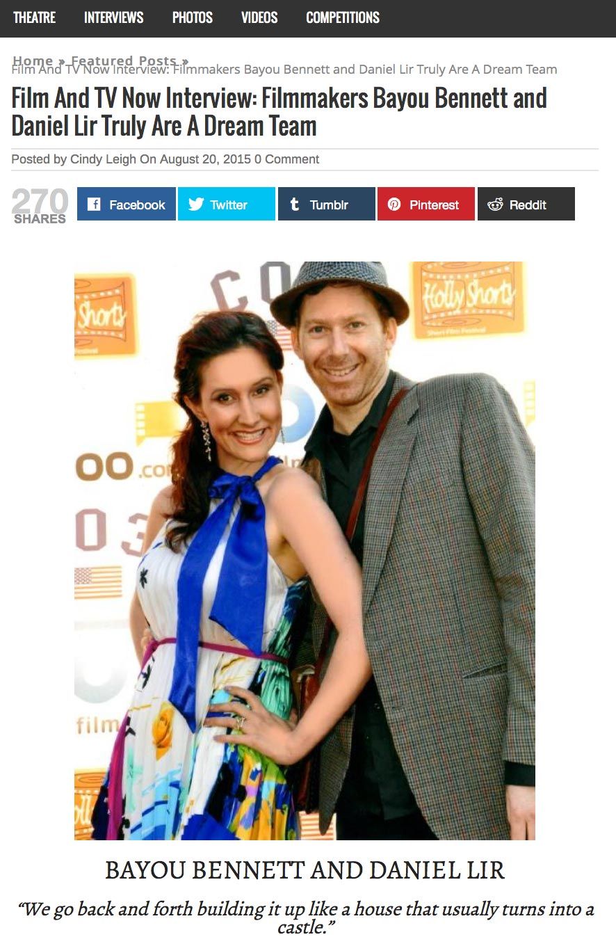 A man and a woman are standing next to each other on a red carpet.