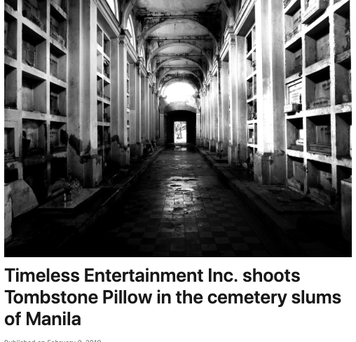 A black and white photo of a tombstone pillow in a cemetery slums of manila