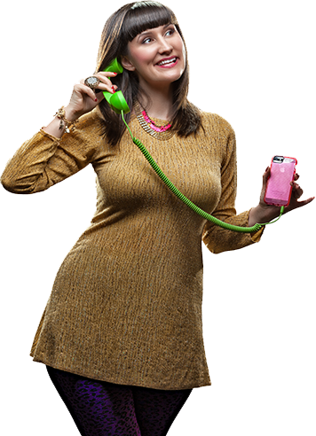 A woman is talking on a green telephone and holding a pink cell phone