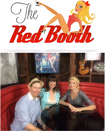 A man and two women sit at a table with the red booth logo above them