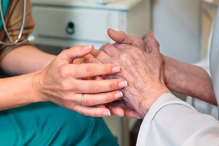 Doctor Holding the Hands of the Patient — Columbia, SC — Johnson Toal & Battiste PA Doctor Holding the Hands of the Patient — Columbia, SC — Johnson Toal & Battiste PA
