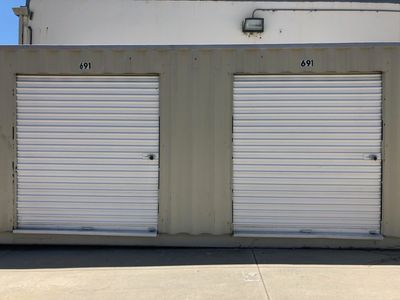 Orange Storage Units — Self-storage in Santa Cruz, CA Two white storage unit doors numbered 69 and 67.