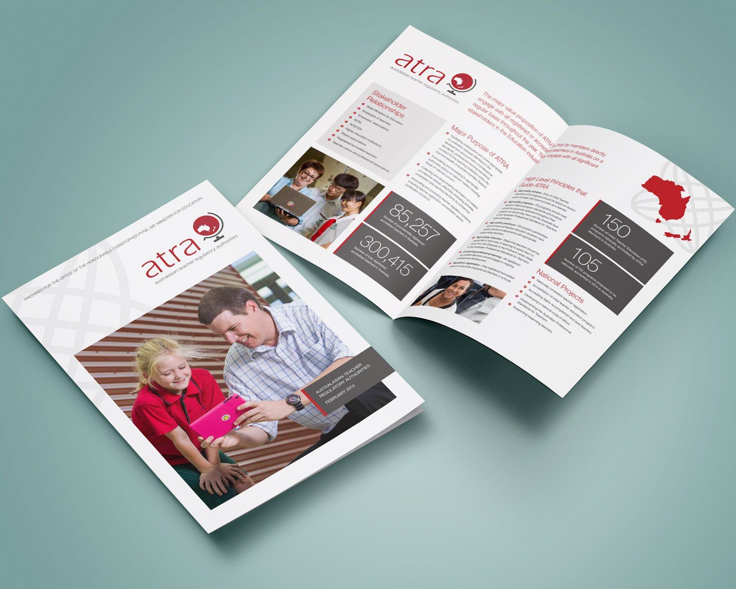 A man and a child are looking at a tablet in a brochure.